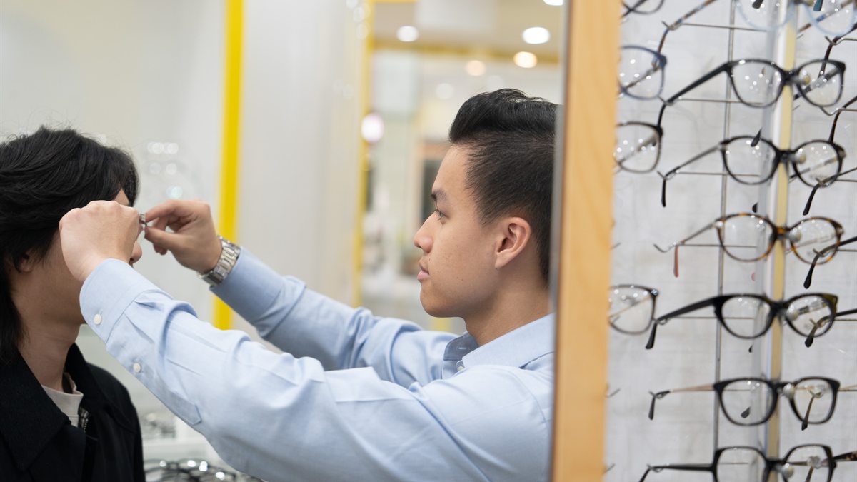 City Optics team member helping a customer in store